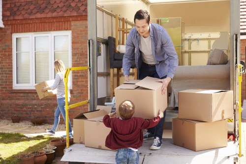 Removal team lifting furniture safely during a house move